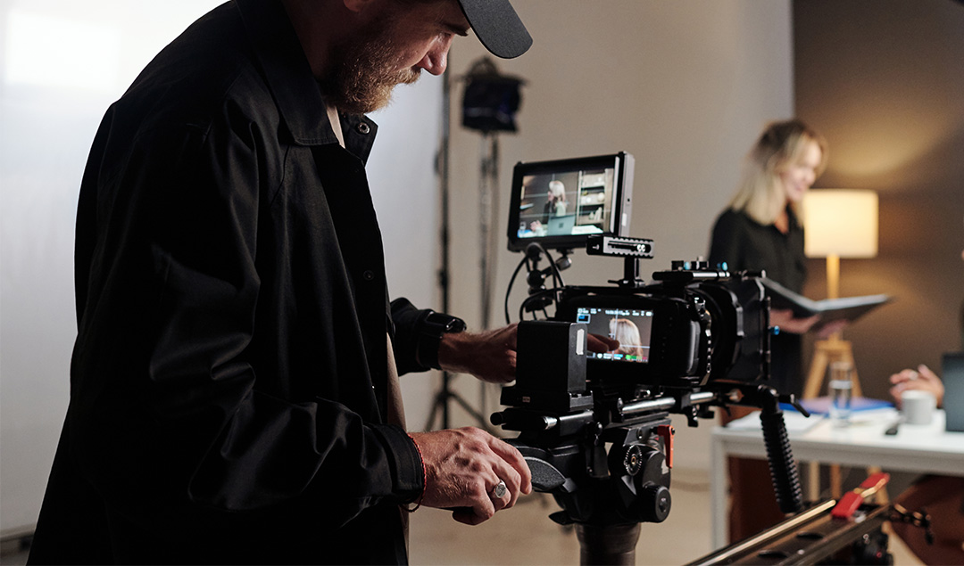Videographer checking camera settings